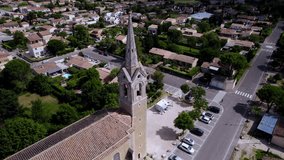 Slow aerial rotating shot around a steeple of a church in downtown Montpellier, France