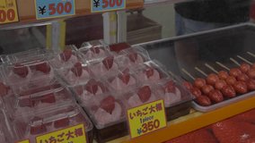 This panning video shows a store front display of candied strawberry snacks and treats.