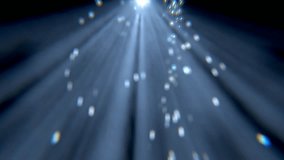 Glittering particle lights in blurry bokeh background. 3d animation.