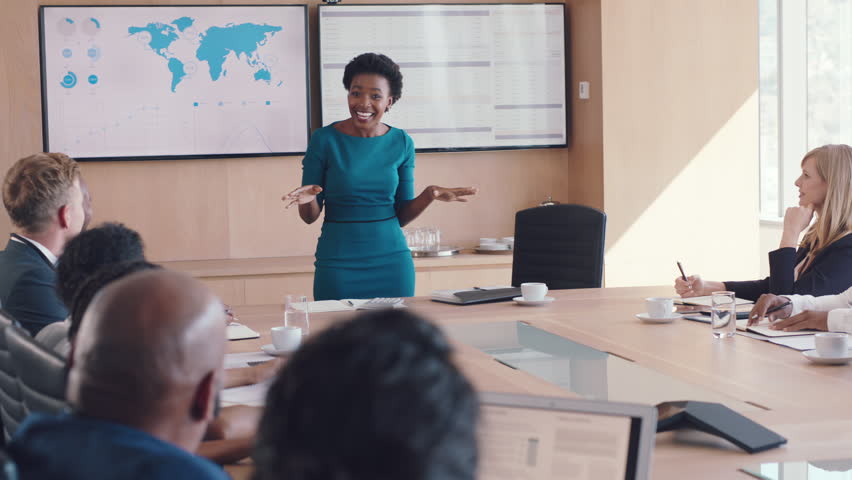 Office, winner and success high five at meeting of business people celebrating company victory. Wow, celebrate and applause of corporate staff for black woman leader in boardroom in Chicago, USA.