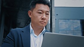 Serious manager boss leader company CEO busy with online project startup analyze data in internet corporate app Korean Chinese 40s middle-aged businessman employer entrepreneur man work with laptop - Powered by Shutterstock - Get 15% off with code: PIKWIZARD15