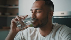 African American healthy sportsman ethnic male guy man athlete sporty trainer indoors drink still cold water with glass drinking refreshment fresh nutrition aqua balance body health care weight loss - Powered by Shutterstock - Get 15% off with code: PIKWIZARD15