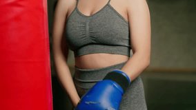 Caucasian sports woman puts on an old boxing glove. Getting ready for training in the gym. - Powered by Shutterstock - Get 15% off with code: PIKWIZARD15