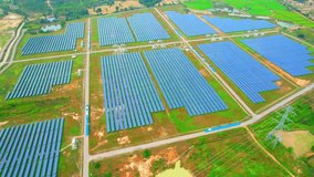 Large solar panels. Innovation of renewable clean energy for the environment. Renewable electric energy industry. technology to solve the energy crisis. southeast Asia. aerial view from drone. 4k
