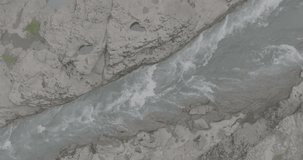 Mountain river. A rapid flow of clean water between rocks. Bubbling water, foam and splashes. Water flow in a mountain gorge. Slow motion 120 fps, ProRes 422, 10 bit ungraded DJI D-LOG video