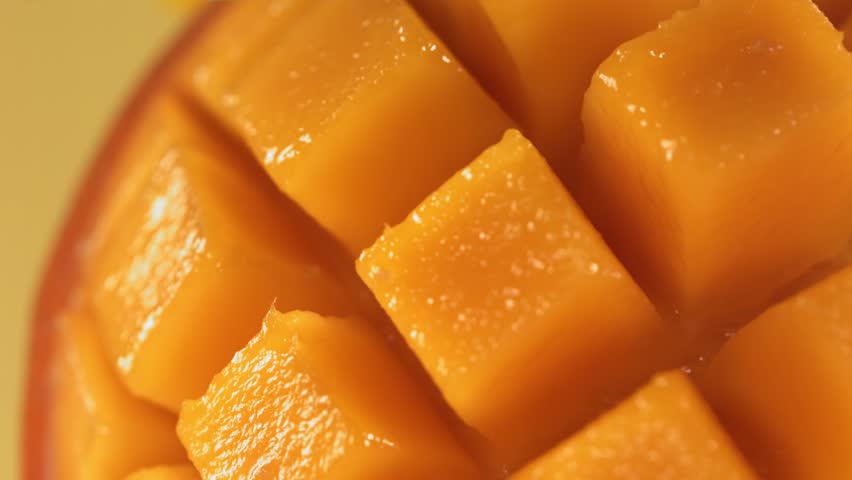 Slow Motion Shot of Mango Juice Splashing through Mango Cube Slices Royalty-Free Stock Footage #1098032605