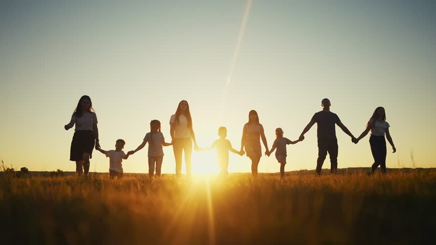 community large family in the park. a large group of people holding hands walking silhouette on nature sunset in the park. lifestyle big family kid dream concept. people in the park. large family Royalty-Free Stock Footage #1098035533