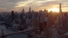 


Aerial Shot of Upper East Side  Skyline in Manhattan, New York City. Amazing Cloudy Sky at Sunset. Famous Queensboro Bridge. High Quality Footage Shot from Helicopter over East River. United States
