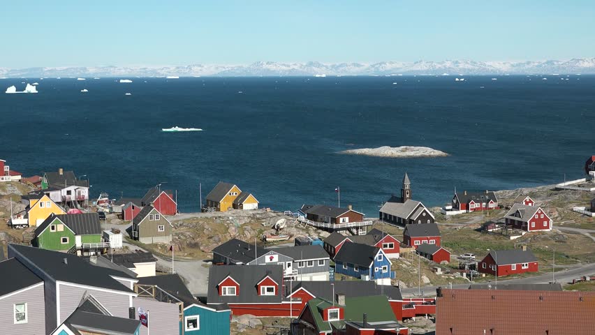 The colorful settlement in central-western Greenland. A typical village in Greenland with colorful houses. Greenlandic fishing town, Old wooden church, town life, beautiful series of Arctic life. Royalty-Free Stock Footage #1098039499