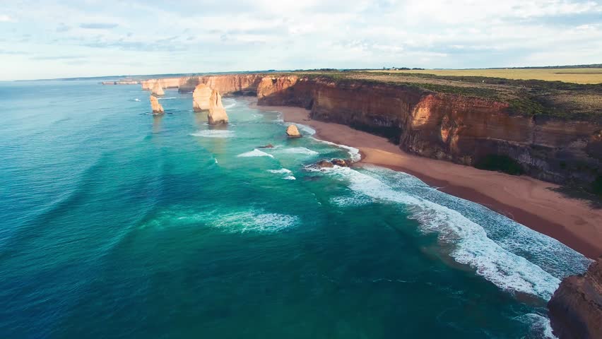 The Twelve Apostles along Great Ocean Road in Victoria, Australia. Port Campbell National Park on a beautiful sunrise, aerial view. Slow motion.