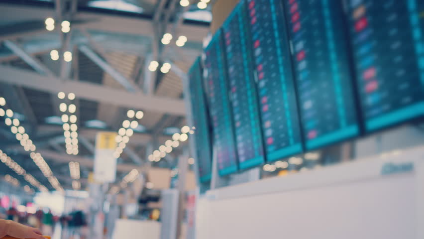 Happy asian woman traveler checking flight schedule board in airport terminal. Tourist journey trip concept Royalty-Free Stock Footage #1098047173