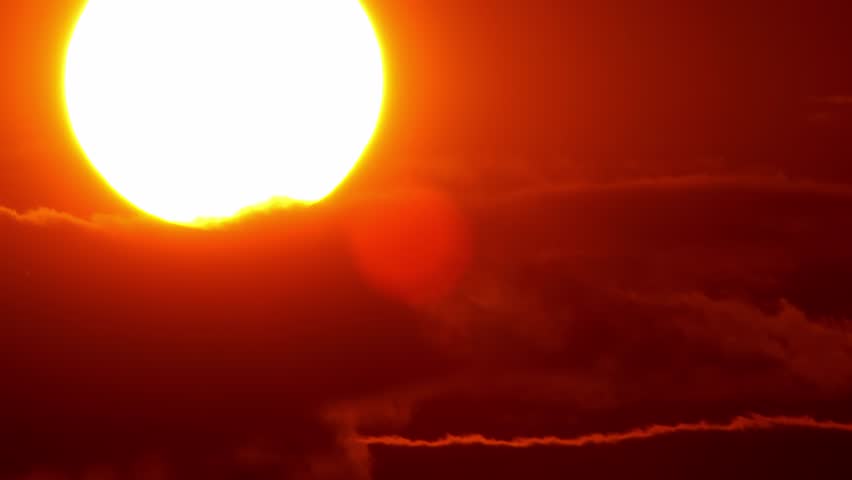 Big bright yellow hot sun disk moves down as sunset. Epic sky and sky line. Amazing orange red yellow colors of the setting sun dusk. Cinematic vibrant colors and time lapse sun set. Royalty-Free Stock Footage #1098058793