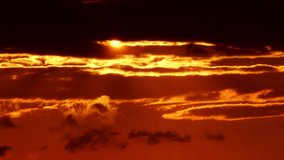 Sunset in the orange yellow red sky timelapse. Epic setting sun as big bright hot disk. Vibrant color background time Lapse. Cinematic sun set at summer sky.