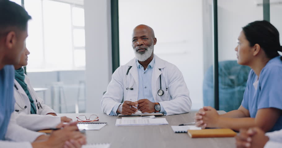 Mature doctors, nurses or teamwork meeting in hospital planning, medical surgery ideas or medicine treatment strategy. Talking healthcare workers, men or women with paper documents in collaboration Royalty-Free Stock Footage #1098059317