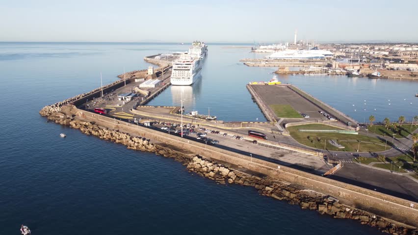 Panoramic view of the city of Civitavecchia with the adjoining tourist port and Forte Michelangelo. Emerald sea and view with tropical palm trees.