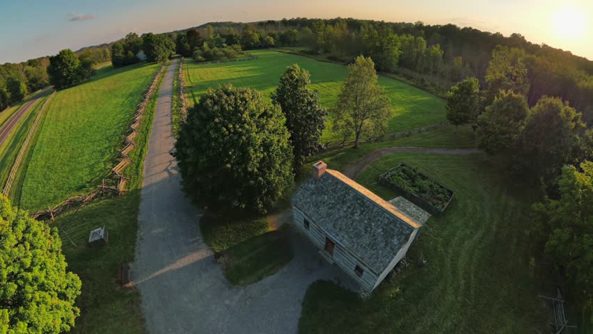 Drone 360 degree view Panning from the Joseph Smith Log Cabin and frame house changing back in time to the 1820s
