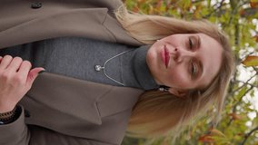 Vertical video, Portrait Stylish Blonde Business Woman in Long Coat. Beautiful Businesswoman Looking Confident Independent Female Executive Enjoying Successful Corporate Career. Slow Motion