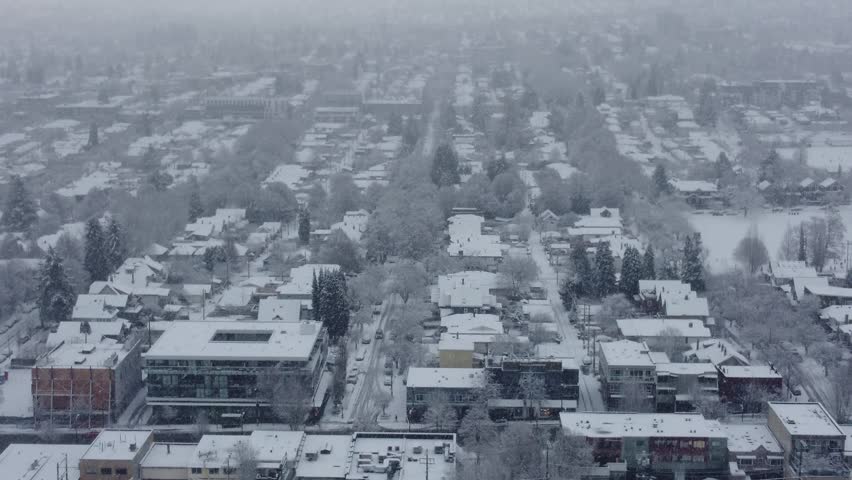 Fly over houses and streets in Vancouver with the heavy snow falling in winter