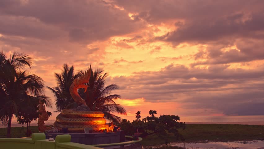 
Scenery sunset behind Naka god of snake statue in the middle of Karon beach Phuket.
Karon beach is a beach is broad and long. 
Sand and beautiful beach suitable for swimming.
cloud scape background.
 Royalty-Free Stock Footage #1098087311