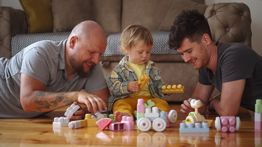 Authentic shot of young happy homosexual male gay family with adopted son toddler baby boyplay together Royalty-Free Stock Footage #1098089475