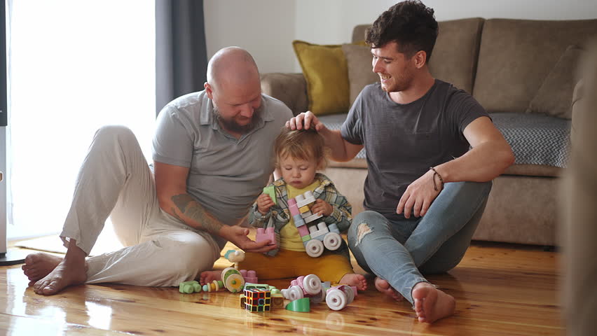 Gay couple brings up a young son and plays with him Royalty-Free Stock Footage #1098093789
