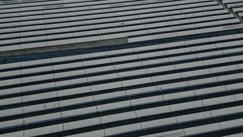 Solar panels of solar power plant covered in snow and ice, drone shot, slow movement forward Royalty-Free Stock Footage #1098094529