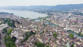 Inscription on video. Zurich, Switzerland. Panorama of the city from the air. View of Zurich Lake. Limmat River Expiry Site. Shimmers in colors purple, Aerial View