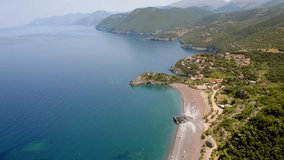 4k drone forward video (Ultra High Definition) of Limnionas beach with huge mountains on background. Summer scene of Euboea island, Greece, Europe. Aegean seascape. Vacation concept background.