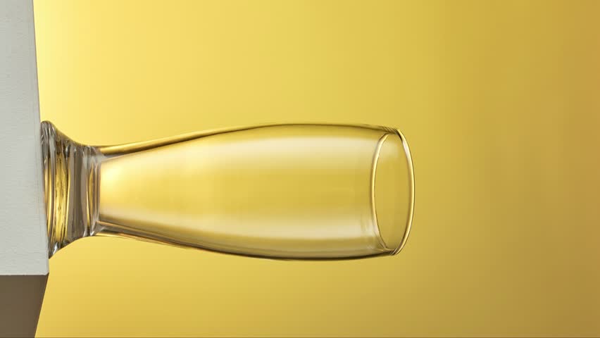 vertical format stop motion animation of beer pouring into glass on yellow background Royalty-Free Stock Footage #1098101369