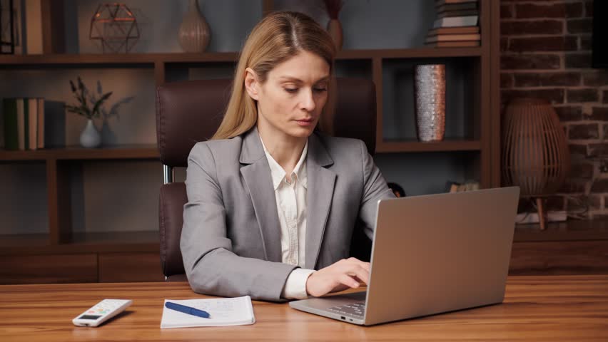 Business woman works on a laptop and feels hot. Female hand adjusting temperature on air conditioner with remote control, Working air conditioner for comfort temperature in home at hot summer. Royalty-Free Stock Footage #1098102823
