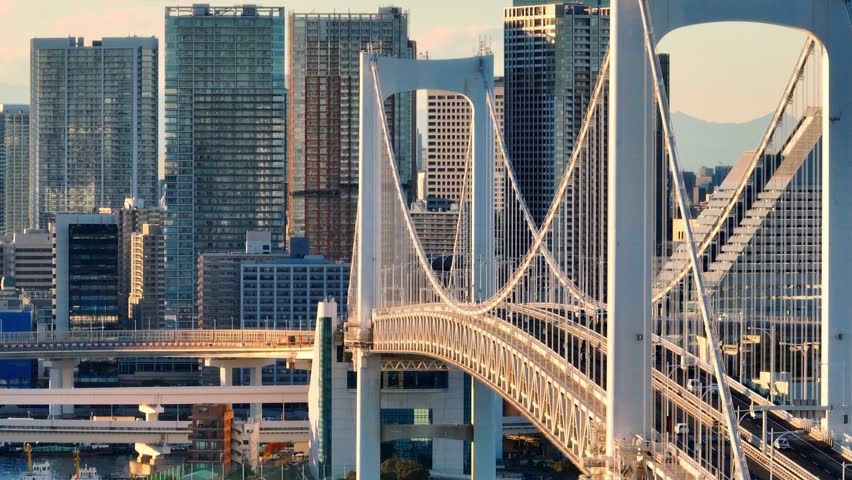 downtown Tokyo aerial view, suspension bridge in the capital of Japan, drone shot of Rainbow bridge in Odaiba, urban busy traffic in Asian metropolis.  Royalty-Free Stock Footage #1098104743