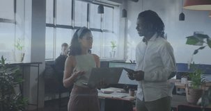 The clip features a group of businesspeople discussing work at a modern office. Global education connections data processing and technology concept digitally generated video.