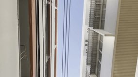 Up-down view video showing the building The sky and the wires tethered between the buildings from an area in a hospital of Thailand