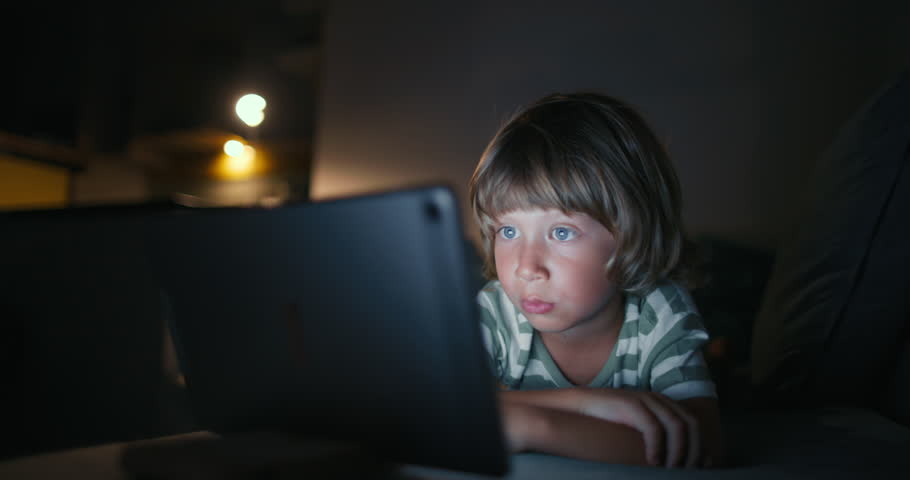 Close up boy 4-5 years afraid child using tablet in living room, Small child hold pad computer surfing not safe content online internet at home concept safety parental security child on social media Royalty-Free Stock Footage #1098119715