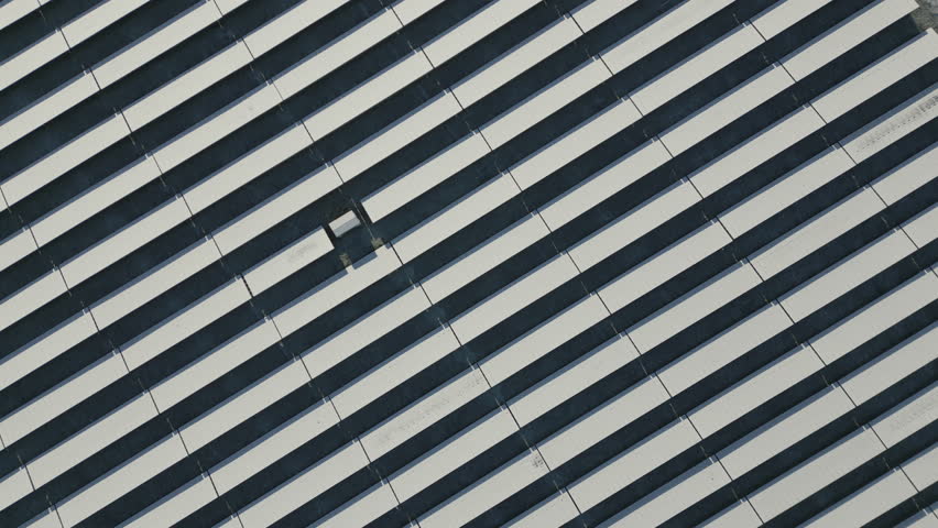 Solar panels of solar power plant covered in snow and ice, diagonal lines, top down drone shot, slow movement forward Royalty-Free Stock Footage #1098121925