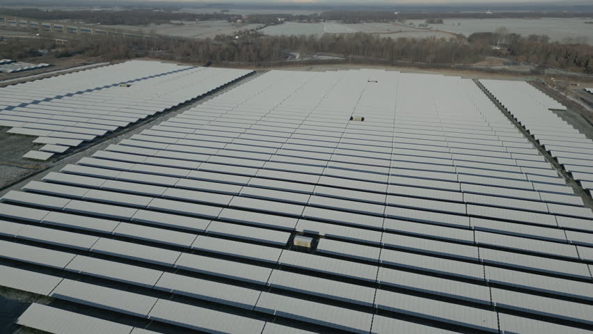 Solar panels of solar power plant covered in snow and ice, frosty landscape, drone shot, slow movement forward Royalty-Free Stock Footage #1098121929
