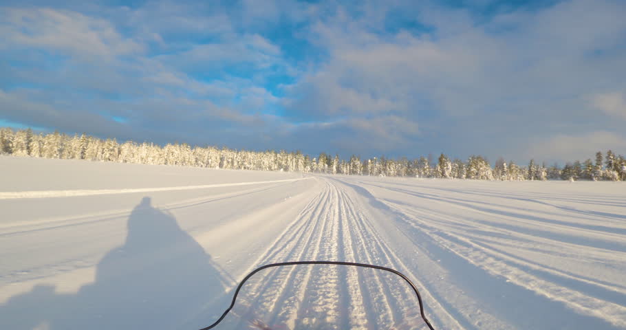 Snowmobile POV driving through Norbotten snowy winter pine forest at sunrise Royalty-Free Stock Footage #1098122711