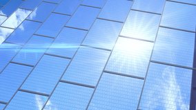 Close-up of the surface of blue photovoltaic solar panels, with beautiful sky time lapse reflection Production of renewable energy concept. Videos loop