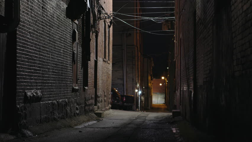 Mysterious person walking down dark alley in city 4k Royalty-Free Stock Footage #1098131853