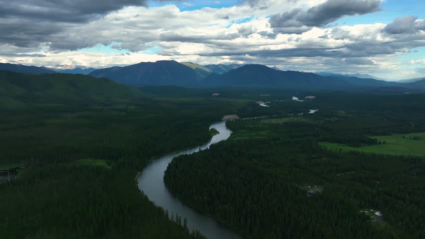 Flathead River Surrounded With Lush Forest In Montana, USA - aerial drone shot