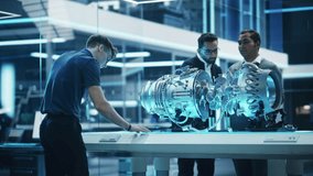 Young Team of Multicultural Engineers Use Blueprints, Tablet and Laptop Computers, Analyze and Discuss How a Modern Electric Turbine Motor Works. High Tech Research Laboratory with Modern Equipment. - Powered by Shutterstock - Get 15% off with code: PIKWIZARD15