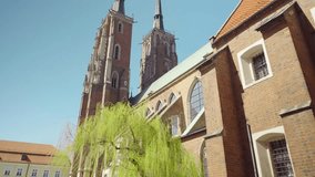 View of the Cathedral of St. John the Baptist in Wroclaw on Ostrow Tumski. Old town, Poland, church, architecture, Roman Catholic, gothic, neo-gothic, gimbal. 4K Video Footage.