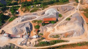 Aerial view from a drone flying over a quarry in the tropics. Southeast asia. Commercial stone industry. Health and respiratory problems. Construction concept. 4K
