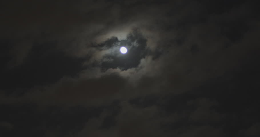 Full moon in the night sky with clouds passing by being lit up by the moons light. Dark and moody, eery cloudy sequence.  Royalty-Free Stock Footage #1098155001