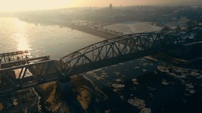 Retro style metal bridge over river with floating ice floes in winter at sunset. Business optimizing of cargo transportation and delivery - Powered by Shutterstock - Get 15% off with code: PIKWIZARD15