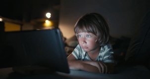 Close up boy 4-5 years afraid child using tablet in living room, Small child hold pad computer surfing not safe content online internet at home concept safety parental security child on social media