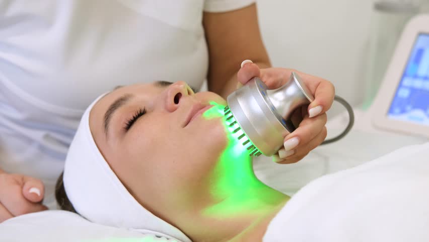 Light infrared therapy. Cosmetology head procedure. Beauty woman face. Cosmetic salon device. Facial skin rejuvenation. | Shutterstock HD Video #1098162765