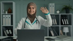 Webcam view happy young doctor woman pediatrician psychotherapist greeting patient online psychology session looking at camera waving hand say hello talking in video chat remote healthcare consultancy - Powered by Shutterstock - Get 15% off with code: PIKWIZARD15
