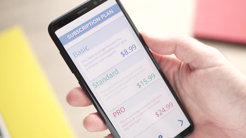 Smart phone app showing different subscription plans to choose from. Different categories available at a different price points Royalty-Free Stock Footage #1098170629