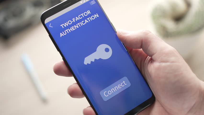 Getting the two factor authentication code on a mobile phone to unlock the account on a separate device. Royalty-Free Stock Footage #1098170637